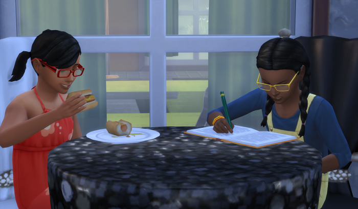 Ari is eating a hotdog while Elleanor scowls at her homework. She's soo cute when she scowls.