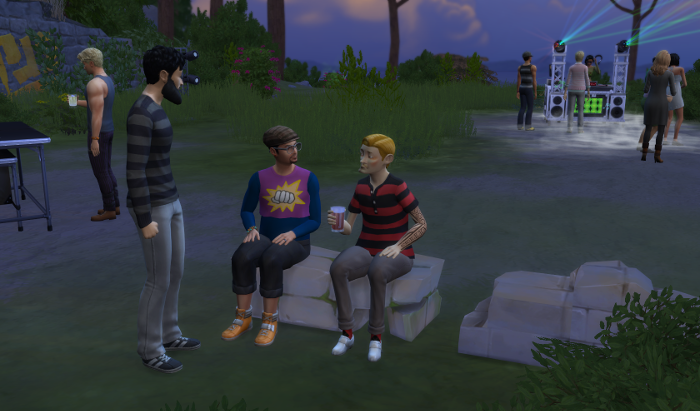 Arturo sits on a rock, the party at the bluffs behind him, the sun is setting. He's chatting to two other men they happen to be Arian and Emeliano but that's not that important.