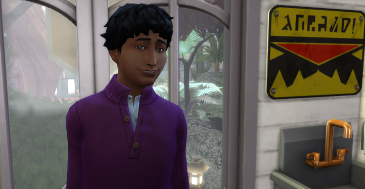 Close up of Lane. He's smiling with short dark hair, and wearing a purple sweater.